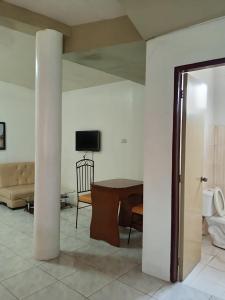 a living room with a table and a couch at Verde Royale Resort in Calasiao