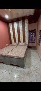 a bedroom with a large bed in a room at Shree ram lodge in Maihar