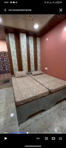 a small bed in a room with at Shree ram lodge in Maihar