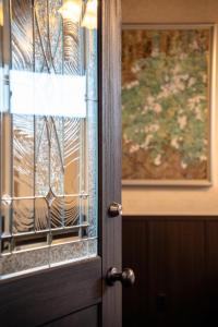 a close up of a door with a window at Taisho Roman-style Private Villa with Original Japanese Art 日本画原画の一棟貸し M's Lumos in Marugame