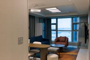 a living room with a table and chairs at Matie Busan Harbor City in Busan