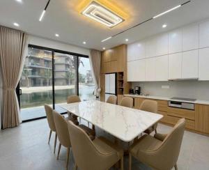 a kitchen with a large white table and chairs at HAHA'S Villa in Binh Hai