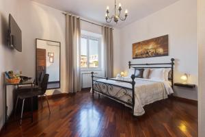 um quarto com uma cama, uma secretária e uma janela em Little Rhome Suites em Roma