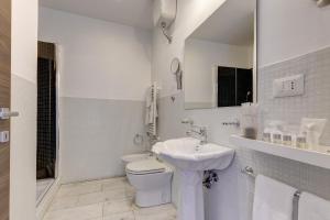 a white bathroom with a toilet and a sink at Little Rhome Suites in Rome