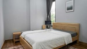 a bedroom with a bed with a television on it at Du Mục in Thôn Mỹ Phước