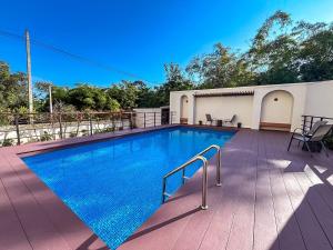 a swimming pool on the deck of a house at La Reina Maroc Hotel ปากช่อง เขาใหญ่ in Pak Chong