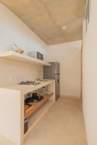 a kitchen with a stove and a refrigerator at Las Guayas, depto Ceh in Progreso