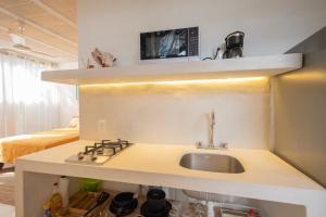 a kitchen counter with a sink and a microwave at Las Guayas, depto Ceh in Progreso +9 photos