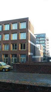un edificio con un coche aparcado delante de él en Marbles Inn, en Ámsterdam