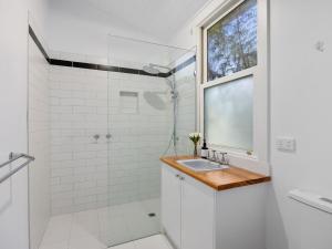 a white bathroom with a sink and a shower at The Gables in Marysville +12 photos