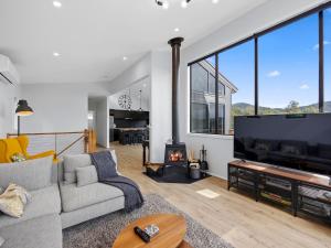 a living room with a couch and a large tv at The Nest on Hull in Marysville