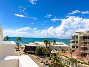 a view of the ocean from the balcony of a resort at Stylish 1 Bedroom with Private Rooftop Spa at the Aegean in Mooloolaba