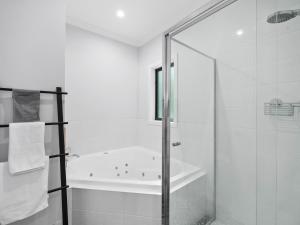 a bathroom with a shower and a bath tub at The Nest on Hull in Marysville +11 photos