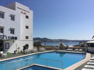 a large swimming pool in front of a building at Apartamentos Alba in San Antonio Bay