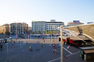 a group of people walking around a plaza in a city at Rooms Garibaldi in Naples