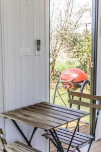 a bench sitting on a porch next to a door at Tiny Balloon House by Tiny Away in Canowindra +18 photos
