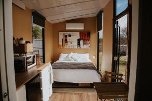a bedroom with a bed in a small room at Tiny Boorowa by Tiny Away in Boorowa