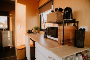 a kitchen with a counter top with a microwave at Tiny Boorowa by Tiny Away in Boorowa