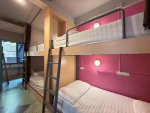 a bunk bed room with two bunk beds in it at Merge Hostel in Samphanthawong
