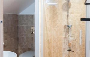 a bathroom with a shower with a toilet and a sink at Grange En Campagne in Vauxaillon