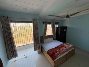 a bedroom with a bed and two windows at Oasis Fun Villa - Pet Friendly Cafe in Indore