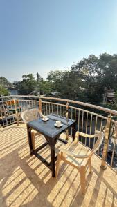 a table and two chairs sitting on a deck at Buena's Haven Travelodge in El Nido +25 photos