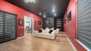 a living room with two white couches and a red wall at Stay & Play Sarasota in Sarasota