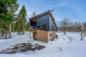 a house in the woods in the snow at COCO VILLA ニセコアンヌプリ-Niseko Annupuri in Rankoshi