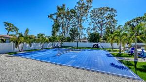 a swimming pool in a yard with a fence and trees at Stay & Play Sarasota in Sarasota