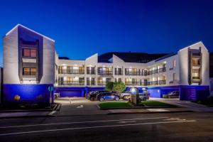 a large building with cars parked in a parking lot at Days Inn by Wyndham San Francisco S/Oyster Point Airport in South San Francisco