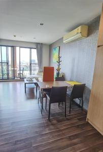 a living room with a dining room table and chairs at BTS Bearing 23Fl 68sqm condo with open city view Shared rooftop and gym in Samut Prakan