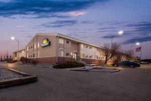 a hotel building with a car parked in a parking lot at Days Inn by Wyndham Minot in Minot