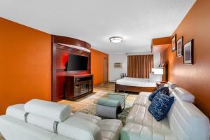 a living room with a couch and a television at Days Inn by Wyndham Minot in Minot