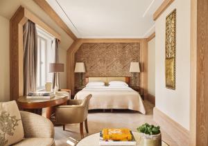 a hotel room with a bed and a desk at Park Hyatt Vienna in Vienna +139 photos