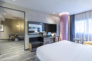 a hotel room with a bed and a flat screen tv at Andaz Condesa Mexico City, By Hyatt in Mexico City