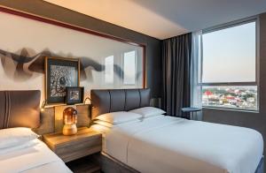 a hotel room with two beds and a window at Andaz Condesa Mexico City, By Hyatt in Mexico City