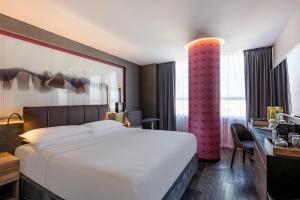 a hotel room with a large bed and a desk at Andaz Condesa Mexico City, By Hyatt in Mexico City