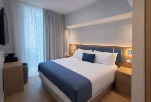 a bedroom with a large bed in a hotel room at Dolce by Wyndham Miami Beach in Miami Beach