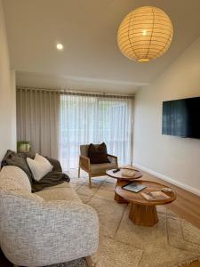 a living room with a couch and a table at Fletcher Christian Apartments - Manava Suites in Burnt Pine