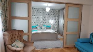a living room with a bed and a mirror at Sweet Home in Timişoara