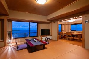 a living room with a view of the ocean at Ryugu Hotel in Nishio