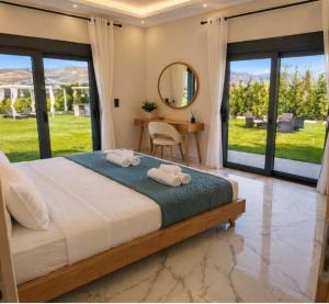 a bedroom with a bed and a table with a mirror at 500 sqm Private Garden, Outdoor Kitchen, near Falasarna & Balos Beach in Falasarna