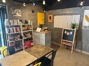 a room with two tables and a book shelf at Osoha guest house in Samcheok