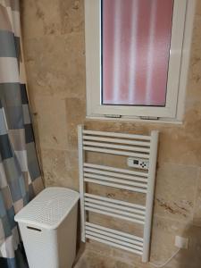 a window in a bathroom with a heater and a trash can at Nice studio 5 minutes walk from the beach in Cagnes-sur-Mer +13 photos