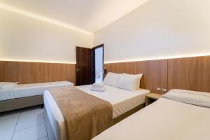 a hotel room with two beds and a window at Hotel Brasil in Penha +67 photos