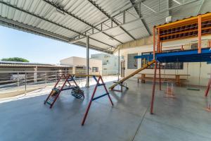 a play area with a slide and a playground at Hotel Brasil in Penha