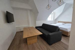 a living room with a couch and a bed at Apartmány Bojnický Vínny Dom in Bojnice