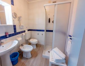 a bathroom with a shower and a toilet and a sink at Hotel Park Spiaggia in Grado +37 photos