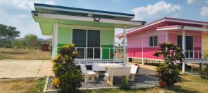 a house with a table and chairs in front of it at ณ กาญโฮม NaKan Home in Ban Hin Hak