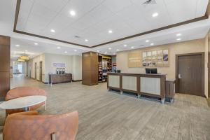 a lobby of a hospital with tables and chairs at Hampton Inn & Suites Bend in Bend